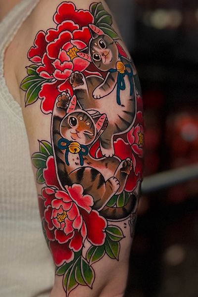 Tatuoija Nat Jiménezin tekemä kissatatuointi käsivarteen.