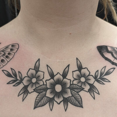 Kukkatatuointi old school-tyylillä naisen rinnassa. Tatuoijana on toiminut Bryan Scott tatuointiliike Leimasta.